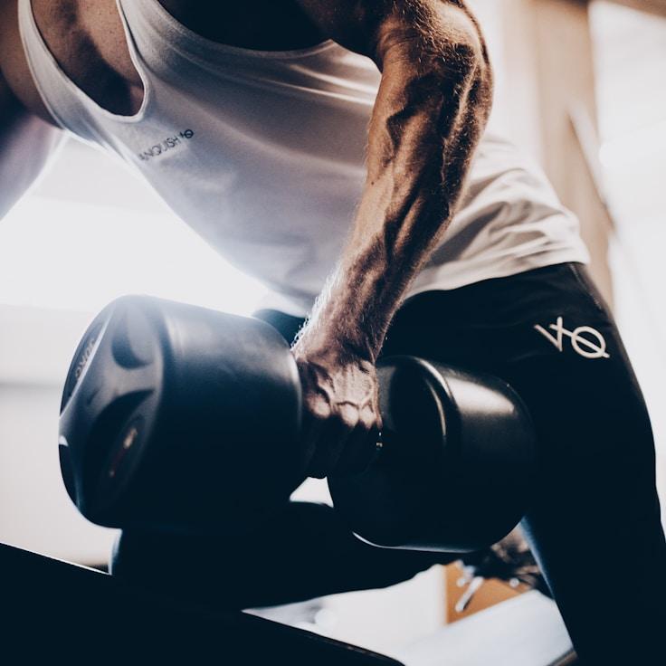 Interior of a professional gym with weight training equipment and mirrors